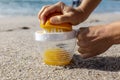 Freshly squeezed orange juice against the backdrop of the ocean in a juicer