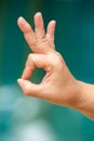 Woman`s right hand symbol meaning ` OK ` in bokeh blue swimming pool background, Asian body skin part, Symbol, Gesturing