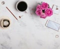 Woman`s workplace with coffee, phone and roses