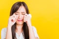 Woman sad she crying wiping tears from eyes with a tissue Royalty Free Stock Photo