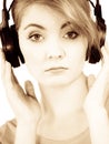 Woman sad girl in big headphones listening music Royalty Free Stock Photo