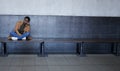 Woman, sad and tired with depression in subway for bad memory, grief and lonely on travel. African girl, person and