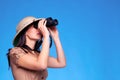 Woman in safari hat searching with binoculars Royalty Free Stock Photo