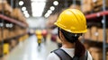 Woman in safety helmet at logistics center with blurred background and text placement