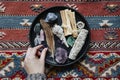 Woman with sage and crystals ready for smudging