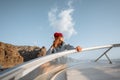 Woman sailing on the yacht near the rocky coast Royalty Free Stock Photo