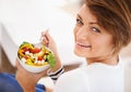 Woman, salad and happy portrait with eating food for diet, detox and breakfast on sofa at home. Person relax and healthy Royalty Free Stock Photo