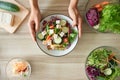 A woman with salad Vegetables, cucumbers, sunflower sprouts, tomatoes, cauliflower, carrots, lettuce, and tofu to prepare food. Royalty Free Stock Photo