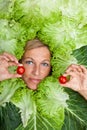 Woman with salal leafes around her head.