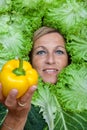 Woman with salal leafes around her head.