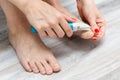 woman sanding her toenails with a sander