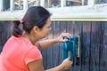 Woman sanding wood of house Royalty Free Stock Photo