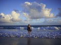 Woman on a sandy beach on a cloudy day