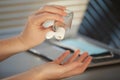 Woman Sanitizing Hands in Office Close Up