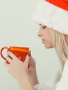 Woman in santa christmas hat drinking tea or coffee Royalty Free Stock Photo