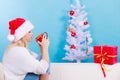 Woman in santa christmas hat drinking tea or coffee Royalty Free Stock Photo