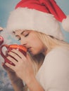 Woman in santa christmas hat drinking tea or coffee Royalty Free Stock Photo