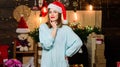 Woman santa claus hat on christmas eve. Lady adorable cute face celebrate christmas at home. Cozy christmas atmosphere