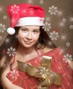 Woman in santa claus hat with present in hands Royalty Free Stock Photo