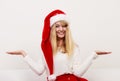 Woman in santa hat with empty hands for copy space Royalty Free Stock Photo