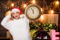 Woman Santa hat hold vintage clock. Time for winter party. Unexpectedly soon. Midnight concept. Make wish. Time to