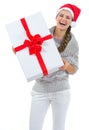 Woman in Santa hat holding big Christmas present Royalty Free Stock Photo