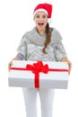 Woman in Santa hat holding big Christmas present Royalty Free Stock Photo