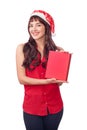 Woman in santa hat holding Christmas gift box isolated on white with copyspace. Happy exited girl unpacking her present Royalty Free Stock Photo