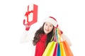 Woman in santa hat holding shopping bags excited Royalty Free Stock Photo