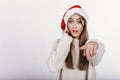 Woman in Santa hat pointing at camera by her finger. Royalty Free Stock Photo