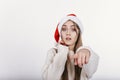 Woman in Santa hat pointing at camera by her finger Royalty Free Stock Photo