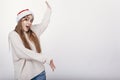 Woman in santa hat pointing on something big Royalty Free Stock Photo