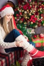 Woman in santa hat putting on gaiters