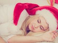 Woman in Santa hat sleeping on couch Royalty Free Stock Photo