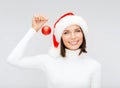 Woman in santa helper hat with christmas ball Royalty Free Stock Photo