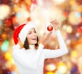 Woman in santa helper hat with christmas ball Royalty Free Stock Photo
