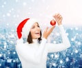 Woman in santa helper hat with christmas ball Royalty Free Stock Photo