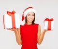 Woman in santa helper hat with many gift boxes Royalty Free Stock Photo