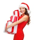Woman in santa helper hat with many gift boxes Royalty Free Stock Photo