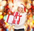 Woman in santa helper hat with many gift boxes Royalty Free Stock Photo