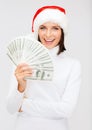 Woman in santa helper hat with us dollar money Royalty Free Stock Photo