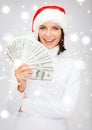 Woman in santa helper hat with us dollar money Royalty Free Stock Photo