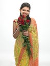 Woman in sari holding red roses Royalty Free Stock Photo