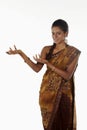 Woman in sari smiling with welcoming hand gesture. Conceptual image