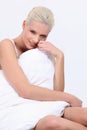 Woman sat covered by duvet Royalty Free Stock Photo