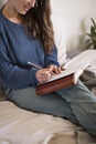 Woman sat writing in her journal