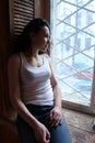 Woman sating beside the window Royalty Free Stock Photo