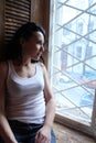 Woman sating beside the window Royalty Free Stock Photo