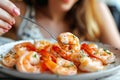 Woman savors cooked prawns at home