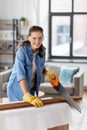 woman with saw sawing wooden board at home Royalty Free Stock Photo